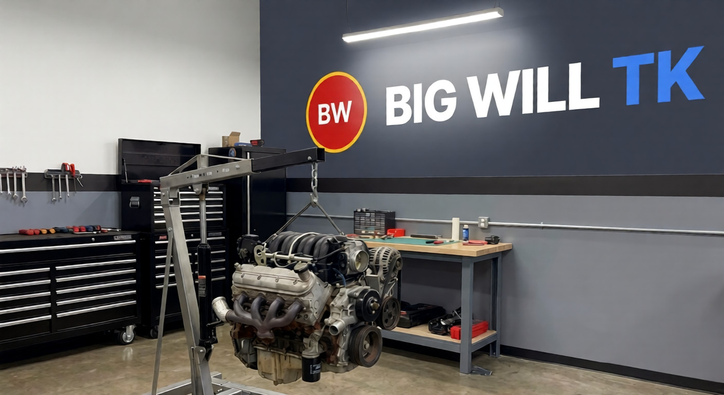 Engine on a hoist in a mechanic shop